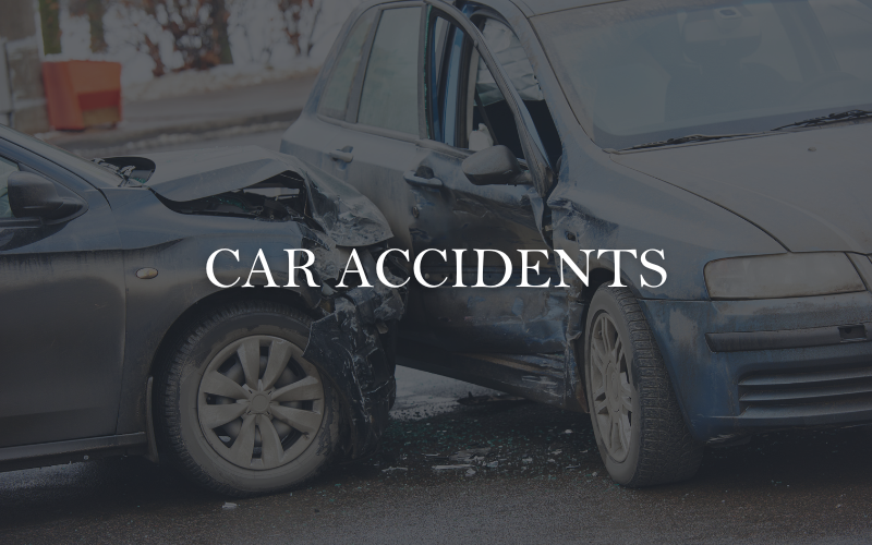 Car accident aftermath showing damaged vehicles on a city street — representing personal injury legal services for auto collision victims. Experienced car accident attorneys help injured clients recover compensation for medical bills, lost wages, and pain and suffering.